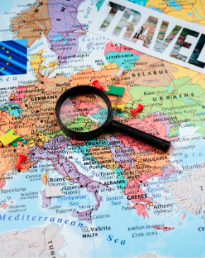 A map of the world with a magnifying glass focusing on the EU